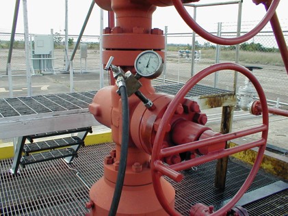 Crew performing gate valve greasing